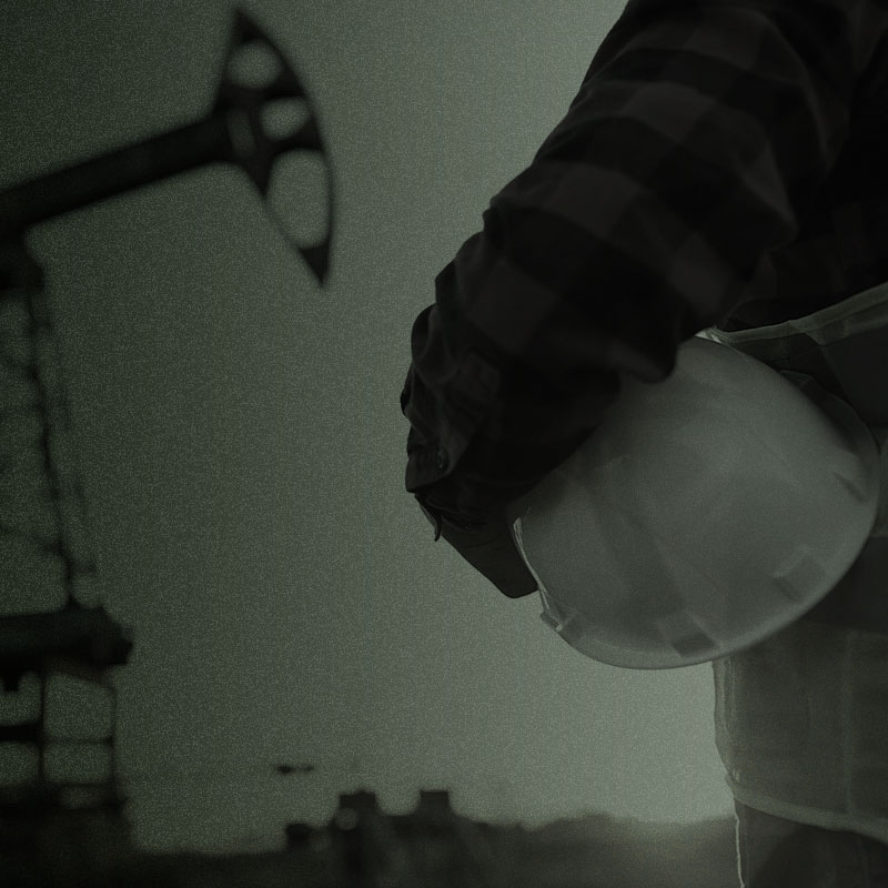 tier 1 contact oil rig worker holding hard hat with grainy overlay