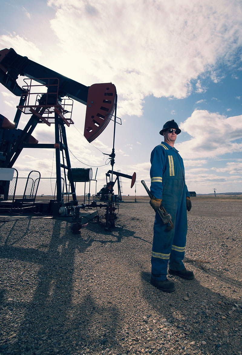 Tier 1 Oil worker standing with tool